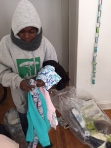 A recipient with a donated Save Darfur sweatshirt, beginning life in the US.